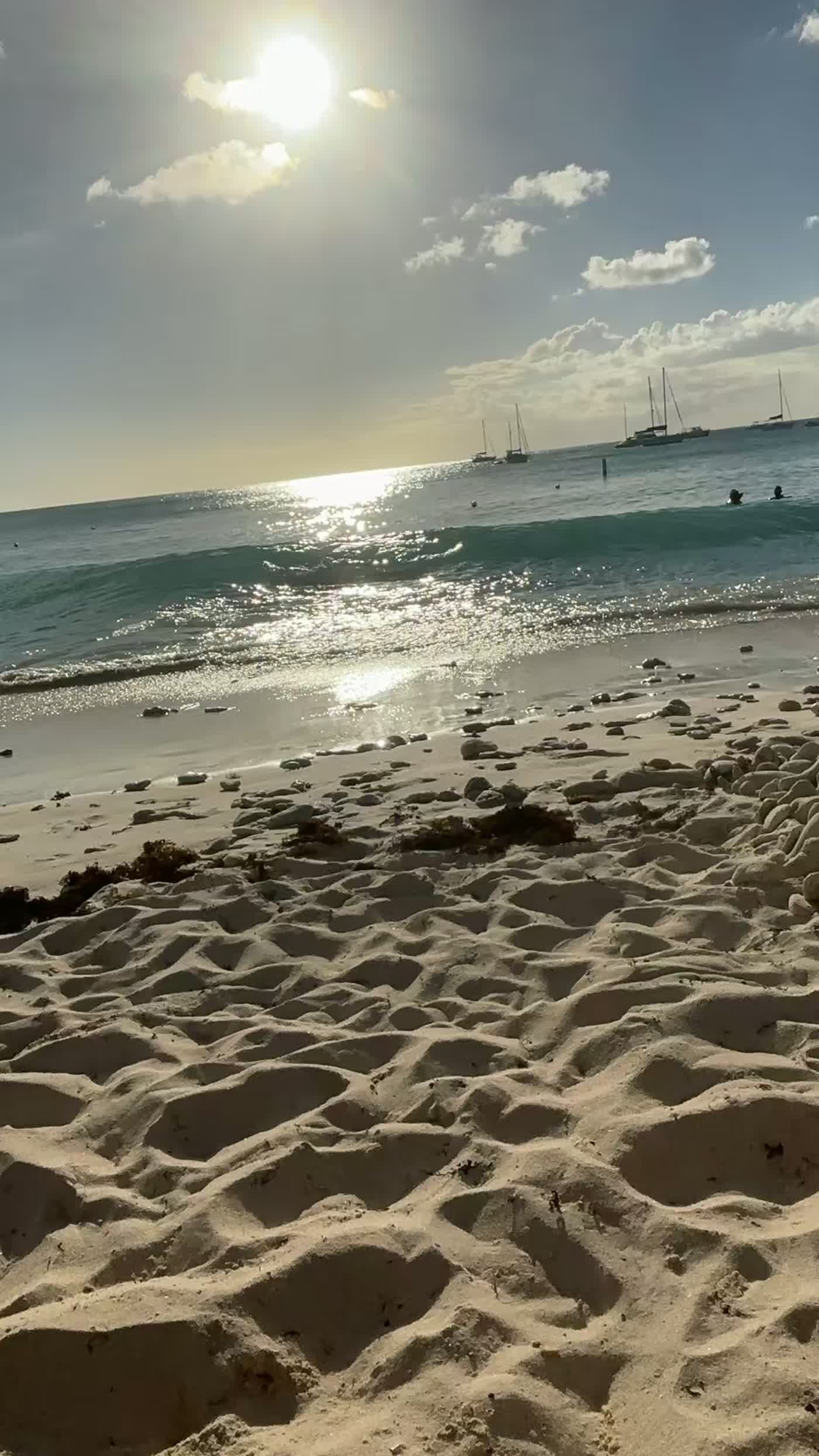 Late afternoon sun over turquoise water and white sand on a Barbados beach