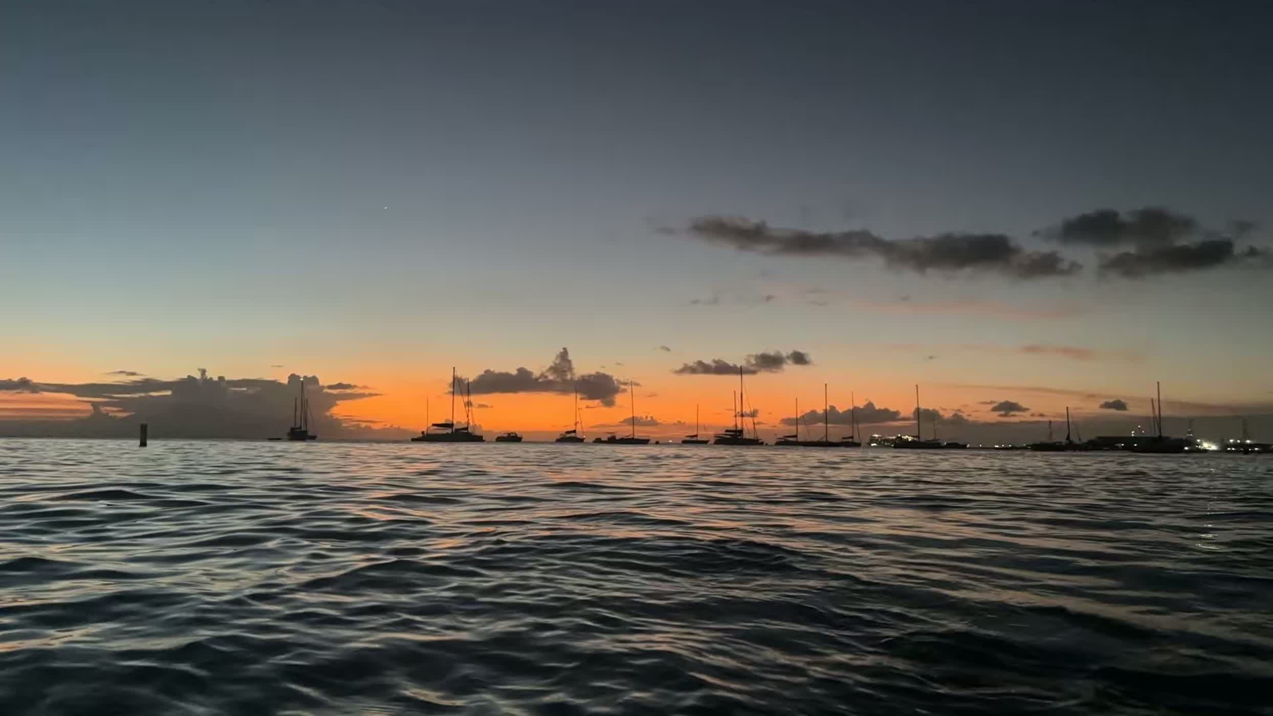 An orange sunset burning along the horizon over the sea in Barbados